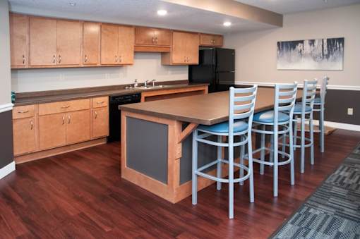 Kitchen in Community Room at Compass Pointe with Full Appliances and Bar with High Top Seating