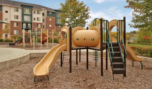 A Playground with a Yellow Slide at Joseph's Pointe at Upper Landing Apartments, St. Paul