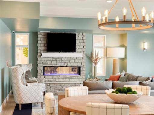 Grey sofa with fireplace and dinning table at The Barnum Apartments, White Bear Lake, 55110