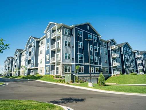 A large apartment complex with multiple buildings and balconies at The Barnum Apartments, White Bear Lake, Minnesota