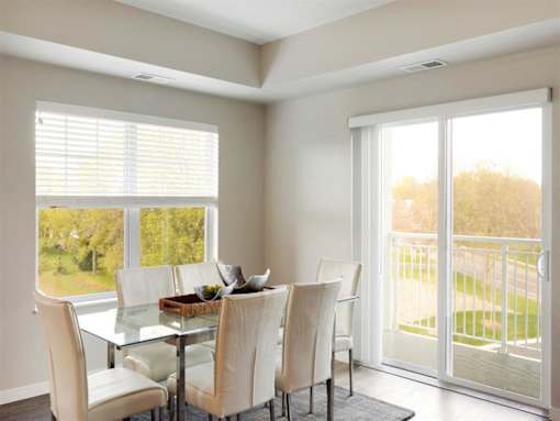 A dining room with a glass table and chairs at The Barnum Apartments, White Bear Lake, 55110