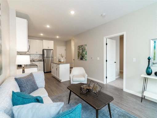 A modern living room with a white couch and a black coffee table at The Barnum Apartments, Minnesota, 55110