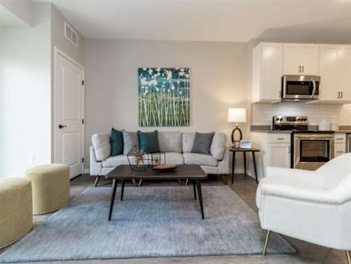A living room with a couch, chair, and coffee table at The Barnum Apartments, Minnesota, 55110