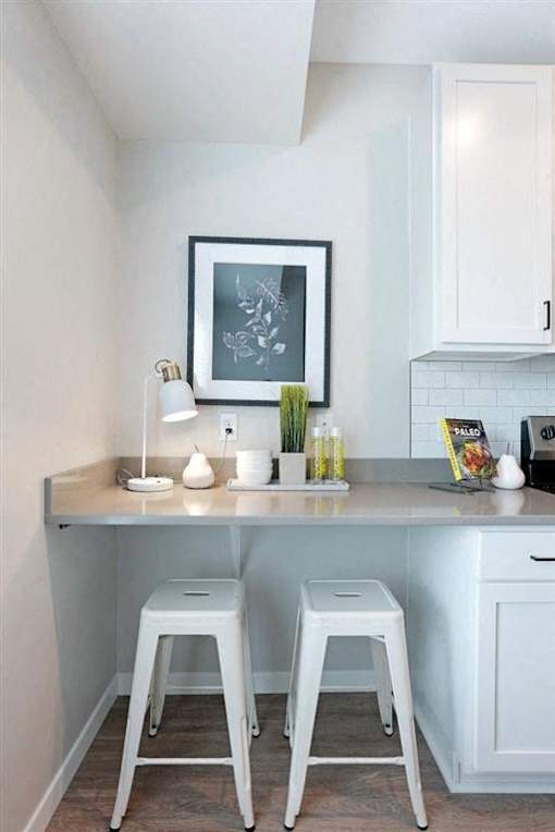 Table lamp on table along with 2 white stools at The Barnum Apartments, White Bear Lake, 55110