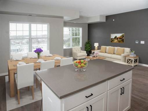 Living room with dinning table at The Barnum Apartments, White Bear Lake