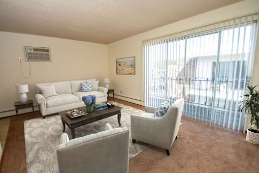 A living room with a couch, chair, and table.
