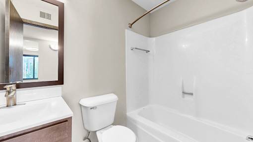 A white toilet sits next to a sink in a bathroom.
