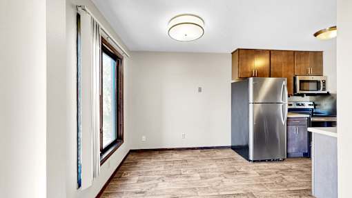 A kitchen with a refrigerator, microwave, and oven.