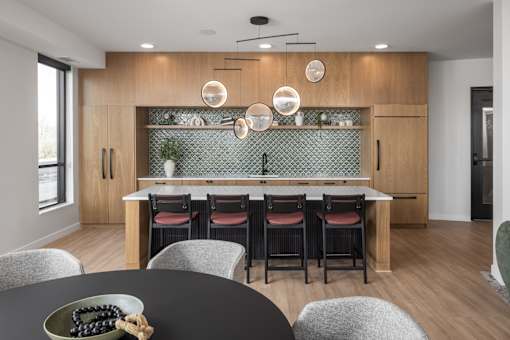 A modern kitchen with a dining table set for four.