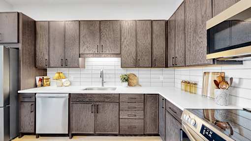 A kitchen with wooden cabinets and a white countertop.