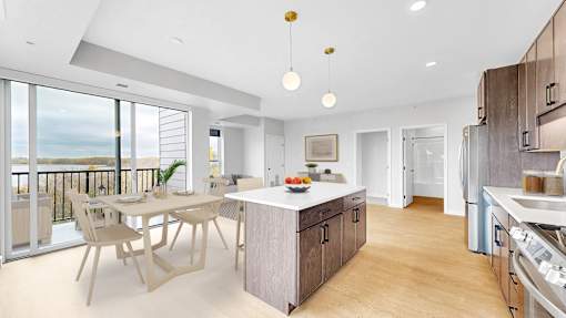 A modern kitchen with a dining table and chairs.