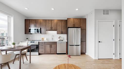 A modern kitchen with wooden cabinets and stainless steel appliances.