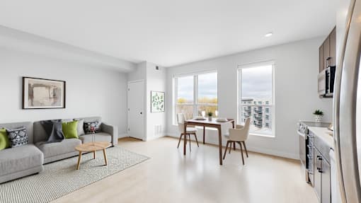 A modern living room with a grey couch and a wooden coffee table.
