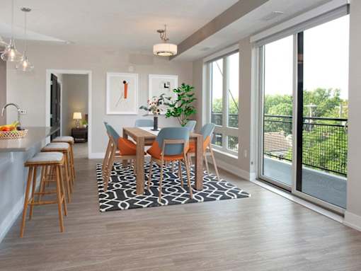 A dining room with a table set for six.