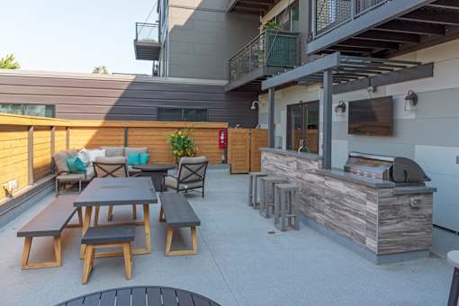 A patio with a bar and seating area.