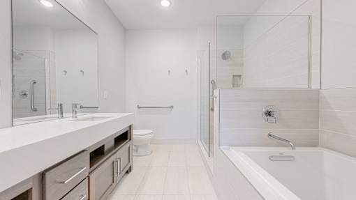 A white bathroom with a walk in shower.