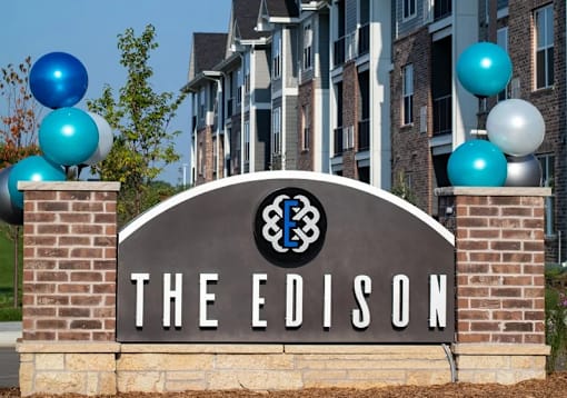 The Edison sign is in front of a building with balloons.