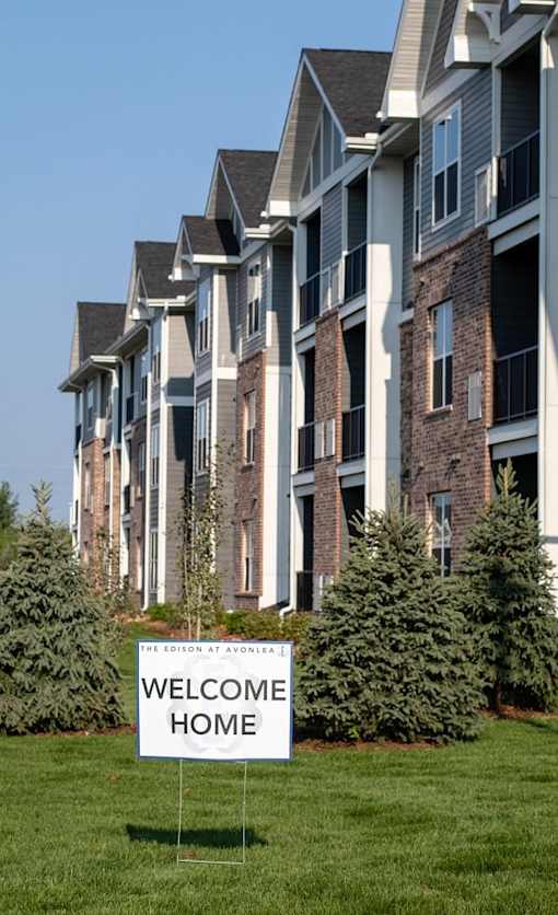 A row of houses with a sign that says Welcome Home.