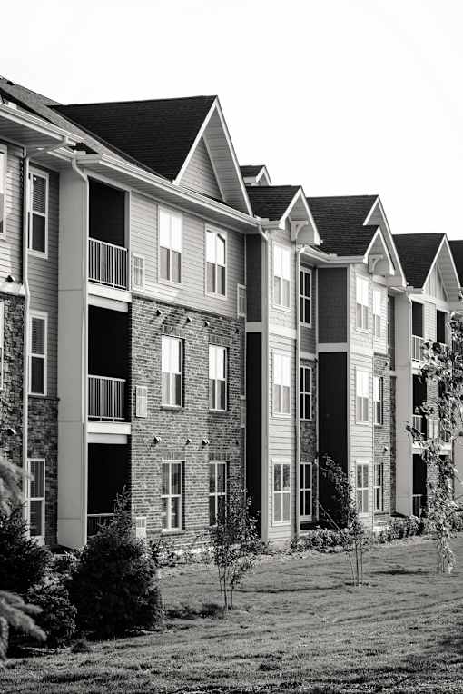 A black and white image of a row of townhouses.