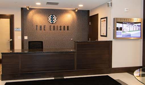 The Edison hotel lobby with a black and white carpet.