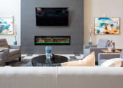 A living room with a television and a fireplace.