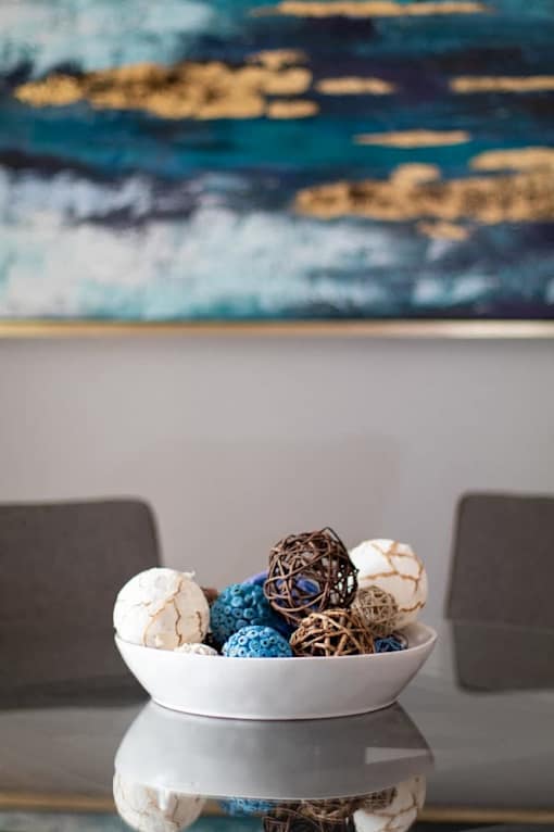 A bowl of assorted bath bombs on a table.
