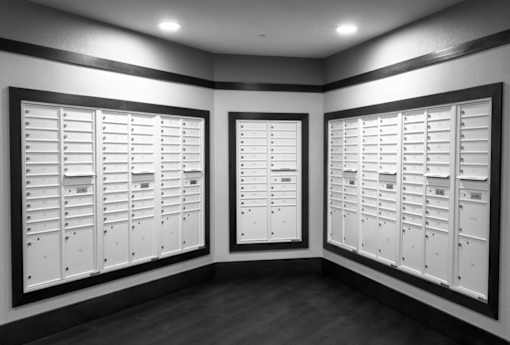A room with two sets of white lockers.