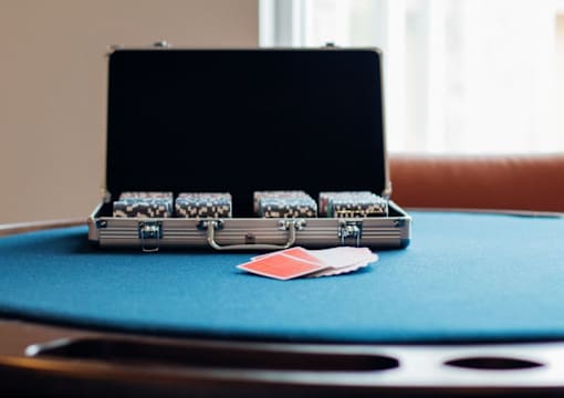 A black case with a handle is on a blue table.