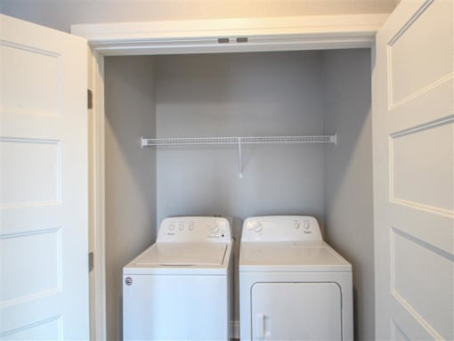 A small laundry room with a washer and dryer.