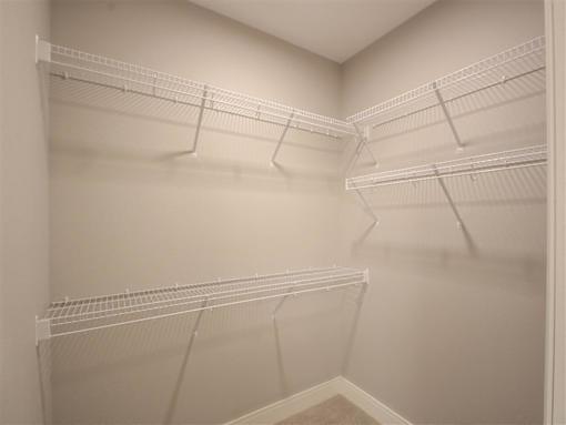 Empty white shelves in a room.