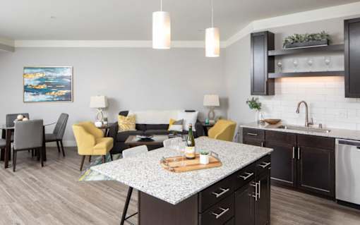 A modern kitchen with a dining table and chairs.