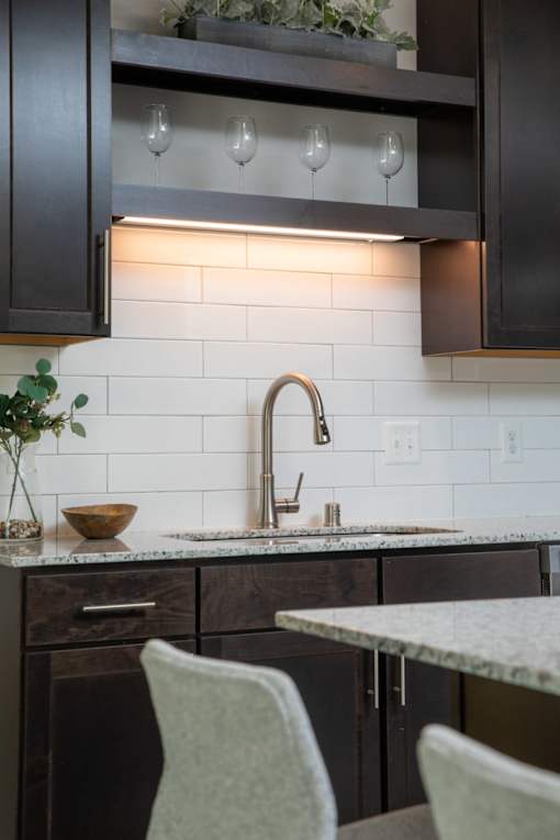 A kitchen with a sink and a counter.
