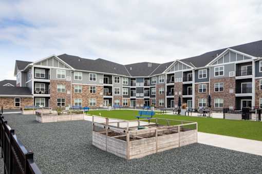 Apartment complex with a playground in the courtyard.