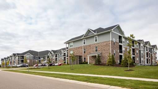 A row of houses with a grey roof.