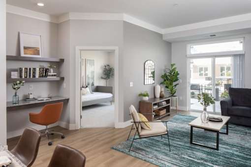 A living room with a brown leather chair and a grey couch at The Edison at Rice Creek I and II, Shoreview, 55126