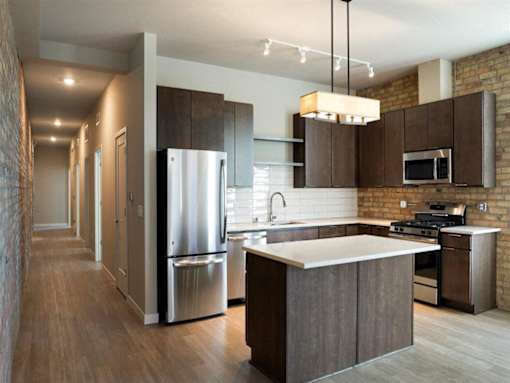 Kitchen with brown cabinets at The M on Hennepin, Minneapolis, MN, 55414