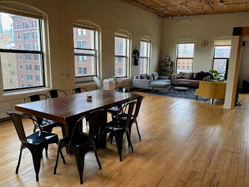 A large room with a long table and chairs.