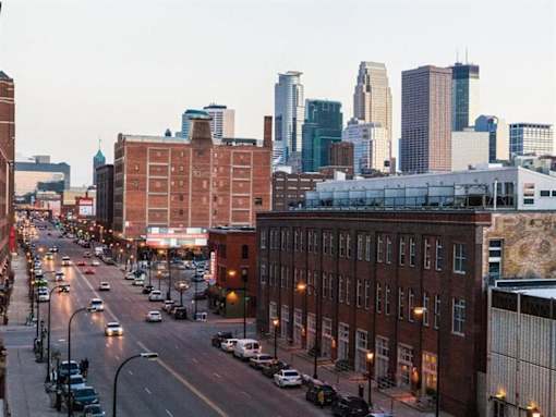 A city street with cars and buildings at The Redwell Apartments, Minneapolis, MN