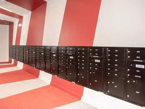 A long row of mailboxes are lined up on a wall at The Redwell Apartments, Minneapolis, 55401