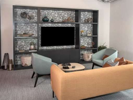 A living room with a television, two chairs, and a coffee table at The Redwell Apartments, Minneapolis
