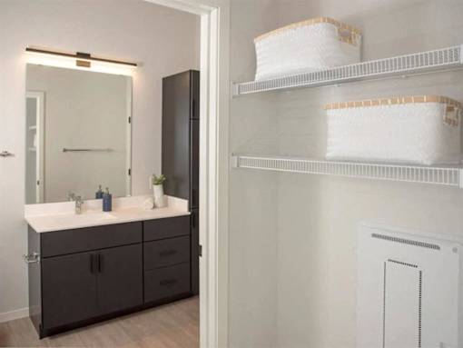 A bathroom with a vanity and a medicine cabinet at The Redwell Apartments, Minneapolis, Minnesota