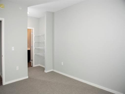 A room with white walls and a carpeted floor.