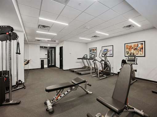 A gym with a variety of equipment including a leg press machine.