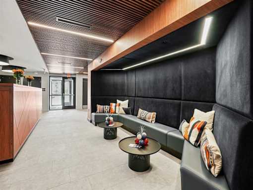 A long hallway with a couch and a coffee table.