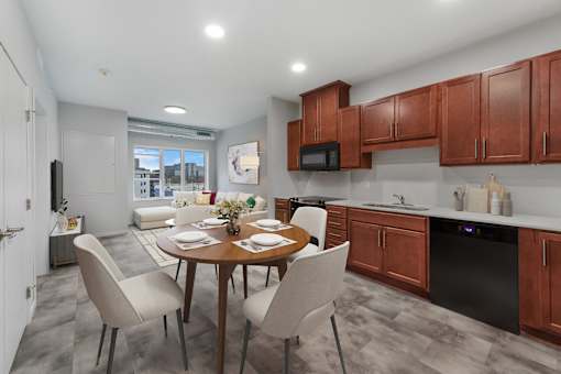 A modern kitchen with a dining table set for four at Soul Apartments, Minnesota