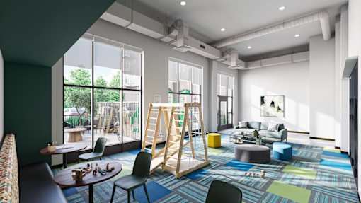 A modern, multi-purpose room with a play area, seating, and a dining table at Soul Apartments, St. Paul, 55107