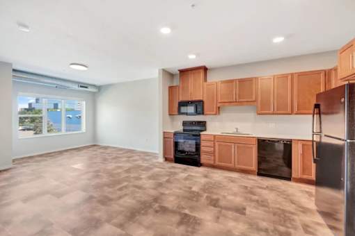 A kitchen with wooden cabinets and a black oven at Soul Apartments, St. Paul, Minnesota