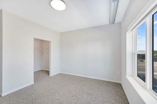 A room with a carpeted floor and a window at Soul Apartments, St. Paul, Minnesota
