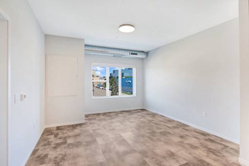 A room with a window showing a cityscape outside at Soul Apartments, St. Paul, 55107