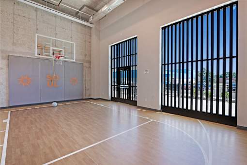 A basketball court with a basketball and a backboard at Soul Apartments, St. Paul, MN 55107